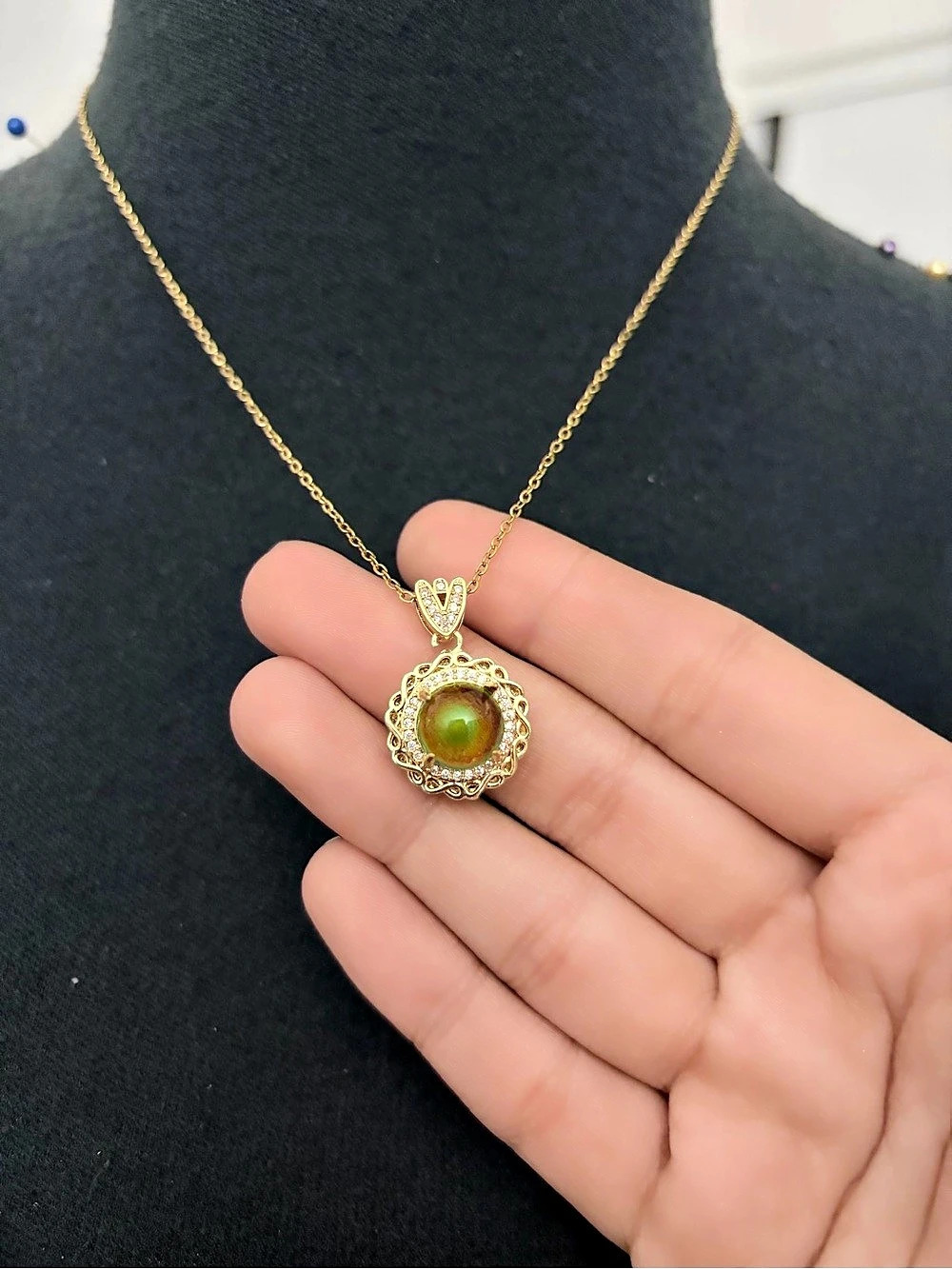 Gold chain with a color changing pendant necklace